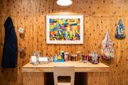 ヘラルボニー店内に展示されたアート作品。手前は週末に作家が創作活動を行う机。制作に必要な美術道具が並んでいる=東京・銀座(提供:ヘラルボニー)