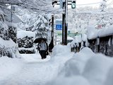 降り積もった雪の中を歩く人たち＝５日午前７時５５分ごろ、富山市五福
